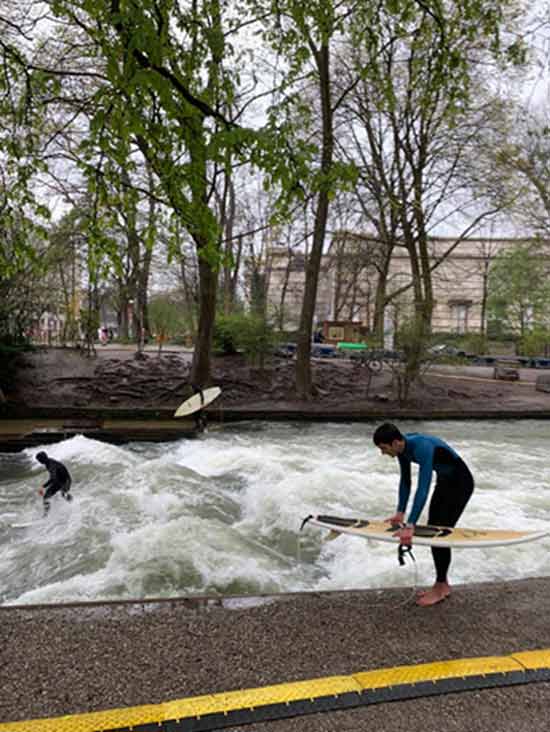 Surfers at the Eisbachwelle in München